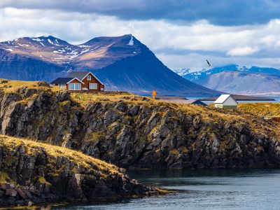 Typical,Icelandic,Landscape,With,Houses,Against,Mountains,In,Small,Village